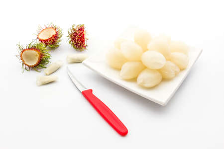 Rambutan is cored with peeling knife, remove the tough central part and seeds from rambutan.の写真素材