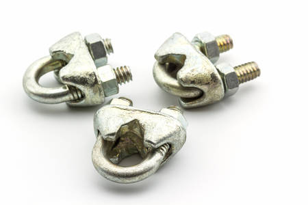 Steel hardware for fitting electrical cable on white background. 