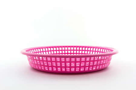 Pink plastic basket on isolated white background. の写真素材