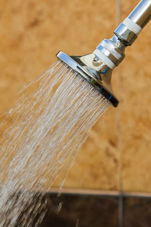 Shining stainless head shower while running water, outdoor at fitness.の写真素材