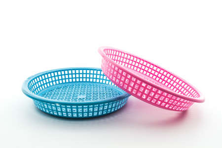 Pink and blue plastic basket on isolated white background. の写真素材