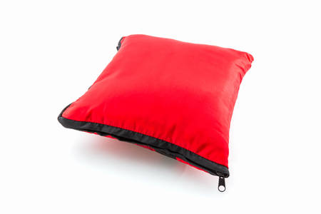 Red bright pillow with zipper on white background.の写真素材