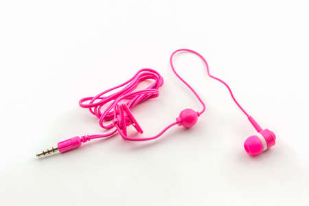 Pink earphones on white background.の写真素材