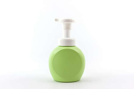 Green bottle on a white background, for shampoo of washing of the head and hair, hygiene and health of hair. の写真素材