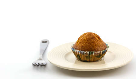 Banana cupcake on white plate with fork. の写真素材