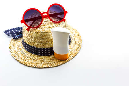 Woven hat, red sunglasses with body lotion on white background. の写真素材