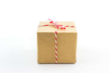 Cardboard carton wrapped with brown paper, tied with string on white background  の写真素材
