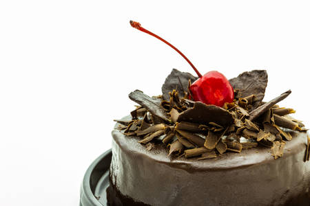 Closeup chocolate cake with red cherry fruit. 