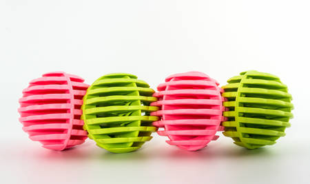  Row of Pink and green washing ball, plastic balls for washing machine. の写真素材