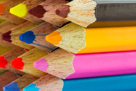 Various color pencils on texture background. 