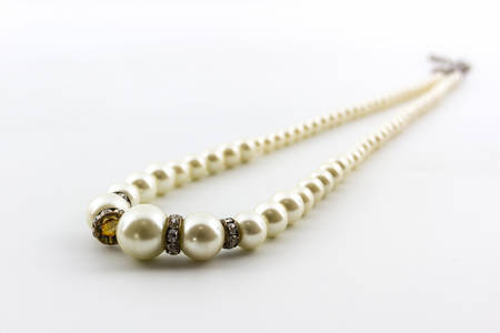 Elegant white pearl necklace on white background. の写真素材