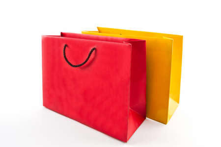 Blank red and yellow paper shopping bag on white background. の写真素材