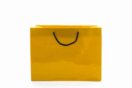 Blank yellow paper shopping bag on white background.