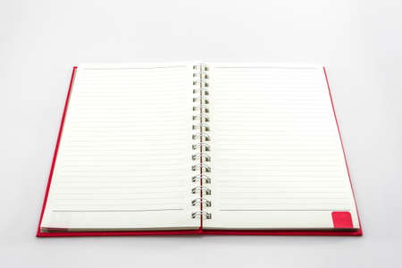 Open red book with lines on white background. 