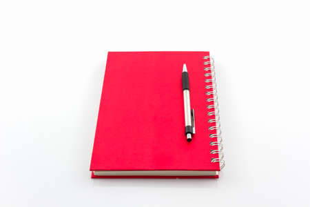 Red Diary Book with pen on white background. の写真素材