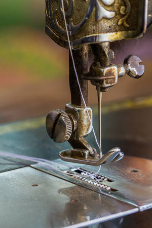 Close up old sewing machine and needle.