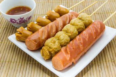 Thai style fried sausage sticks on white plates.の写真素材