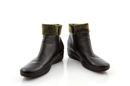 Black Fluffy woolly warm boots on white background.