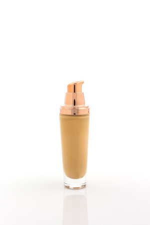 Beige make up foundation in luxurious bottle on white background.の写真素材