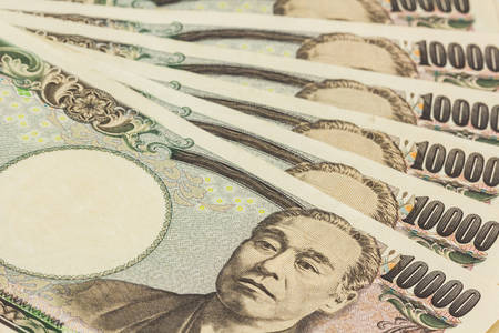 Japanese Yen banknotes on white background.