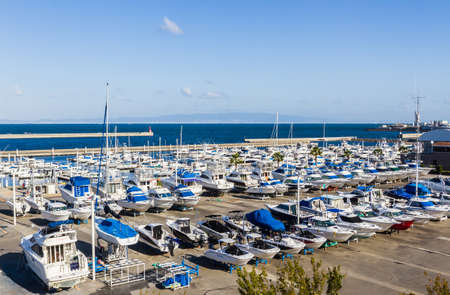 Row of speed boat at marina in Japan, sea and blue sky background.のeditorial素材