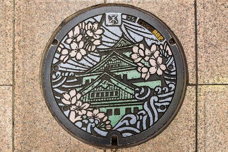 Osaka, Japan - october 23, 2014: Manhole cover in Osaka, Japan. The Osaka castle engraved on to a manhole cover as a symbol of an important city's landmark.のeditorial素材
