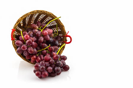 Fresh Red Grape in basket on white background.の写真素材