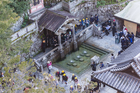 Kiyomizu-dera Temple Kyoto or The temple name means "pure water." , Japan - October 24, 2014: Tourists visit catch and drink the water which is believed to have wish-granting powers.のeditorial素材