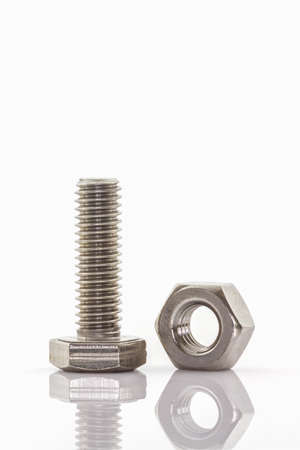 Closeup metal screw and nuts on white background.