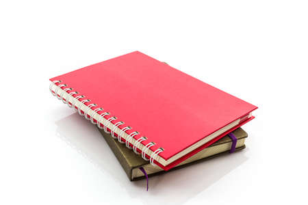 Red and brown diary book on white background.
