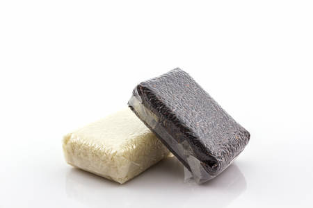 Group of jasmine rice and rice berry in small plastic bag on white background.