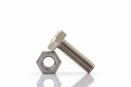 Closeup metal screw and nuts on white background.