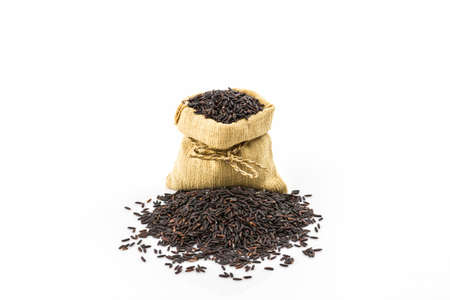 Rice berry in small burlap sack on white background.の写真素材