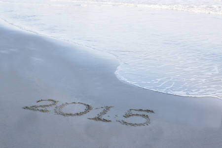 Year 2015 number written on sandy beach.の写真素材