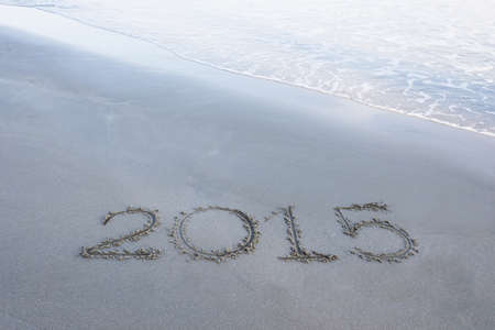 Year 2015 number written on sandy beach.の写真素材