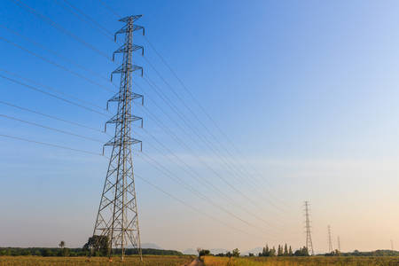 High-voltage tower on blue sky background.