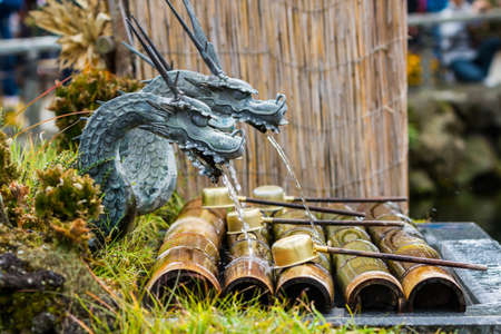 Close up Metal dragon sculpture with water breathing.の写真素材