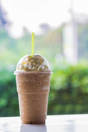 Iced coffee on a wooden table.の写真素材