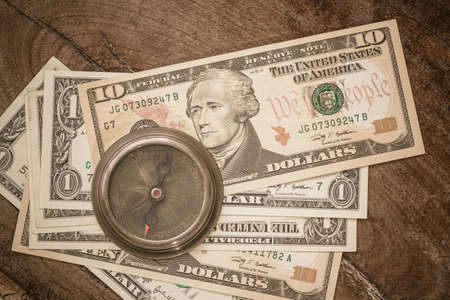 Compass on dollar banknote background, business concept.の写真素材