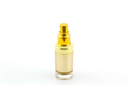 Golden cosmetics bottle, packaging on white background.の写真素材