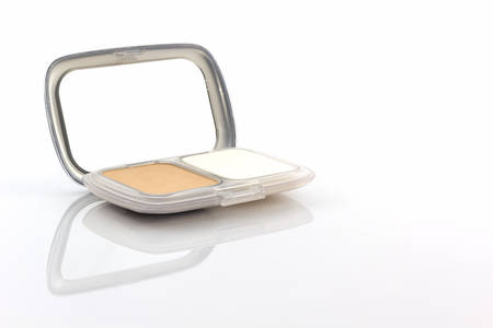 Makeup powder in white case on white background.