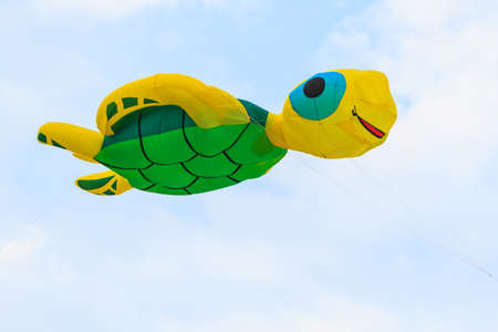 Colorful of kite flying in the wind on blue sky background..の写真素材