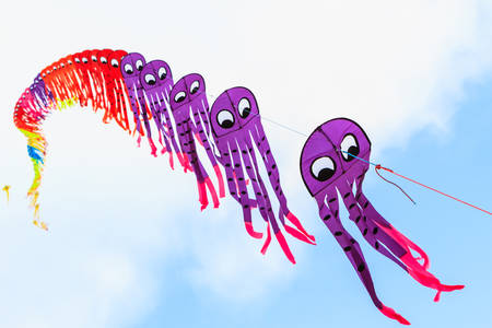 Colorful of kite flying in the wind on blue sky background.の写真素材