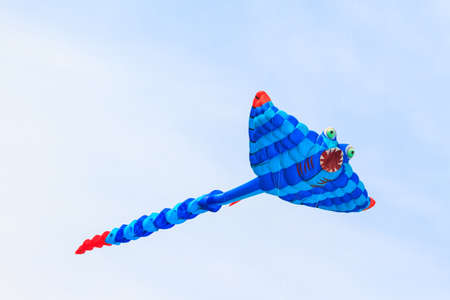 Colorful of kite flying in the wind on blue sky background.の写真素材