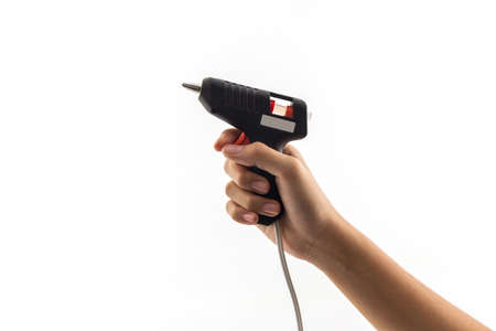 Electric hot glue gun holding on hand.の写真素材