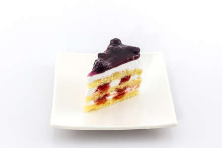 Blueberry Cake slice on white background.