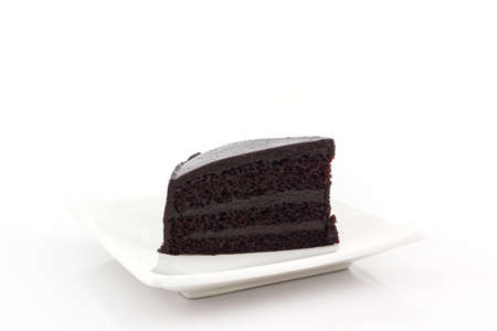 Chocolate cake slice on white background.の写真素材
