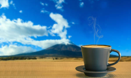 Cappuccino or latte coffee on wooden tableblurred of fuji mountain background Japan.の写真素材