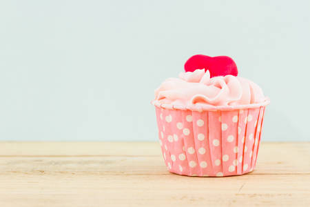 Colorful of sweet cup cake on wooden table.の写真素材