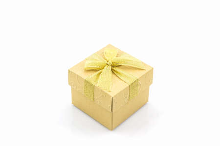 Golden gift box with ribbon bow on white background.の写真素材